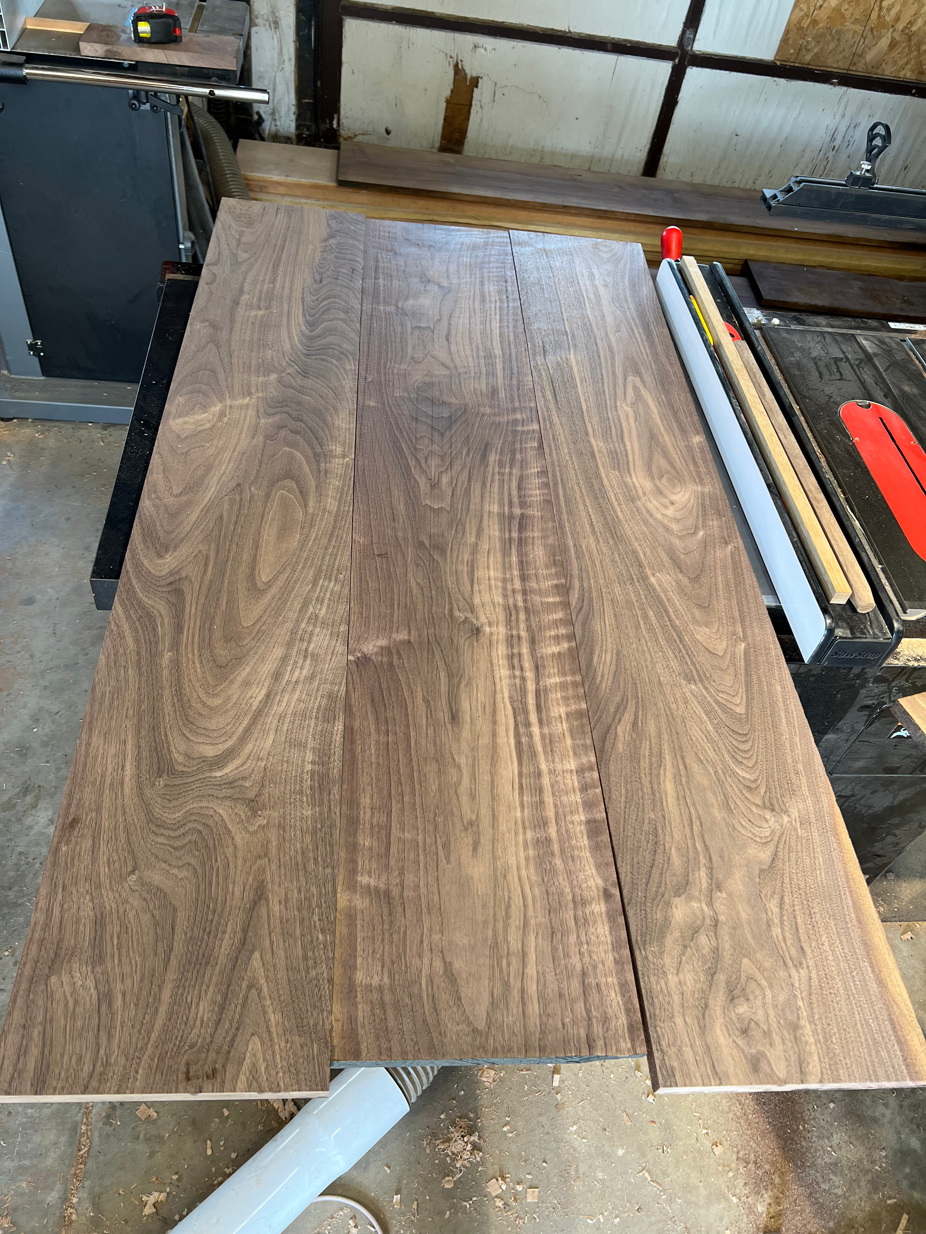 Planed walnut boards ready for glue-up